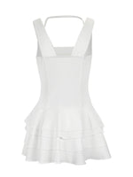White dress with ruffled layers on a white background