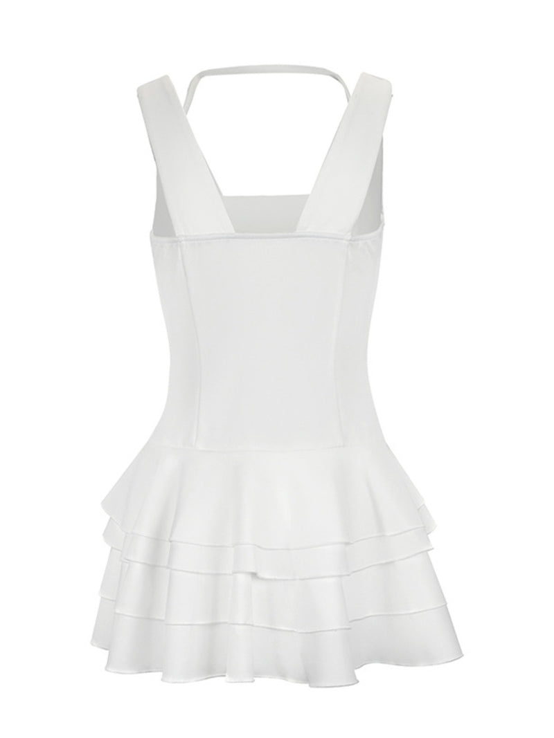 White dress with ruffled layers on a white background
