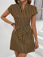 Woman wearing a striped dress with a white background