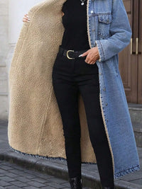 Person wearing a long denim jacket with a beige fleece-lined interior, black pants, and black boots.