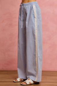 Checkered pants with a stripe on a pink background