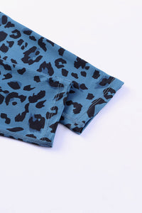 Blue leggings with black leopard print on a white background