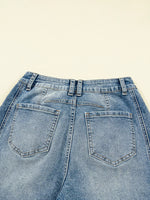Back view of blue jeans on a beige background