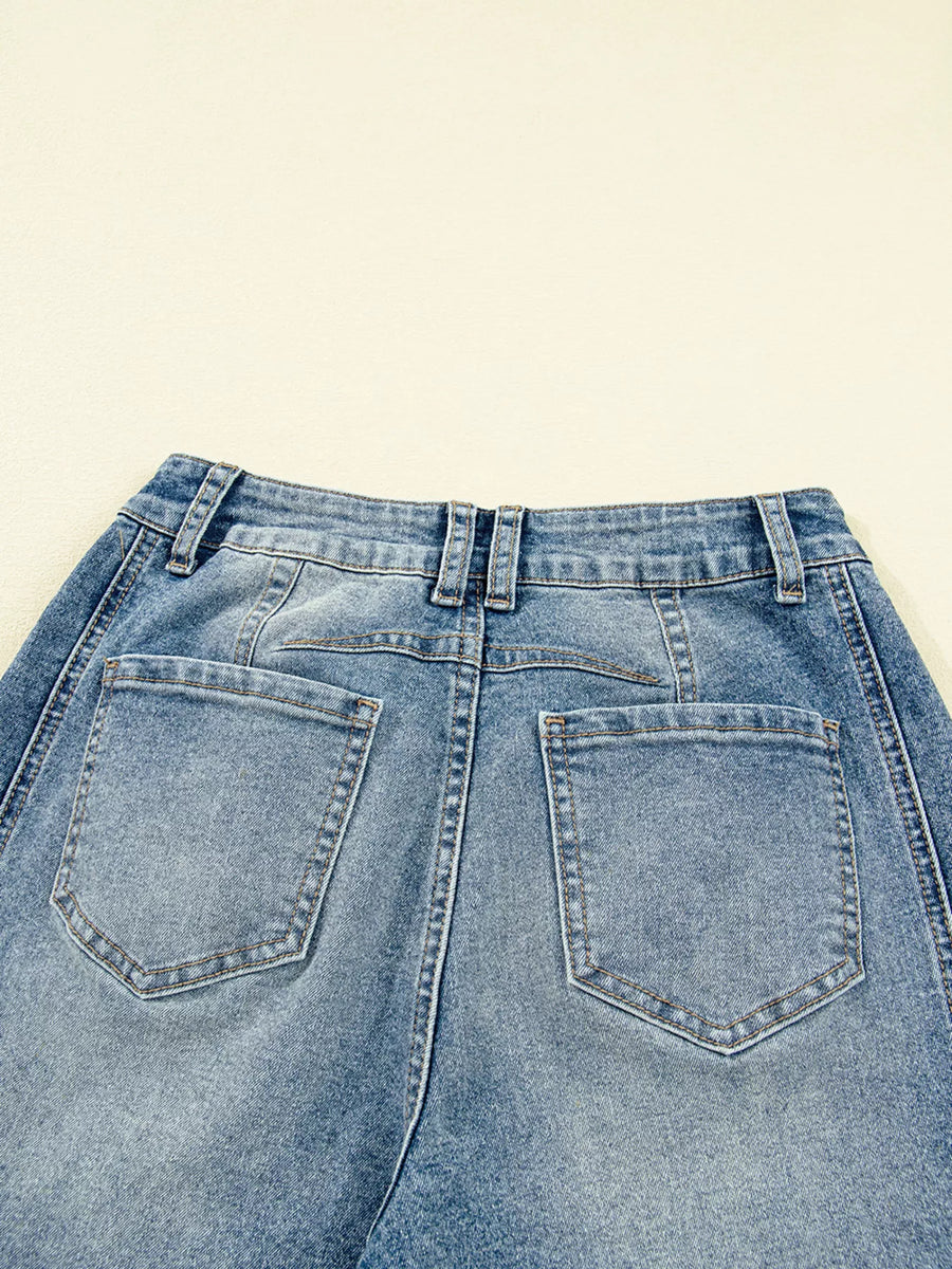 Back view of blue jeans on a beige background