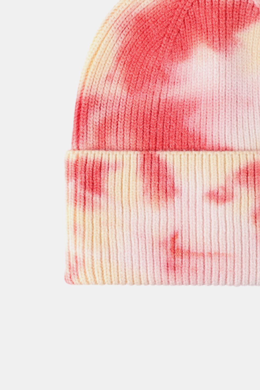 Tie-dye beanie with pink and yellow patterns on a white background