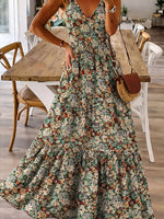 Woman in a floral dress standing in a dining room.