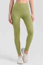 Person wearing green leggings on a white background