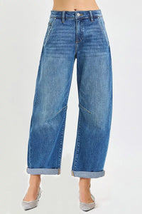 Blue jeans worn by a person on a white background