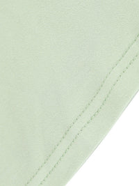 Close-up of a light green fabric with a visible seam on a white background