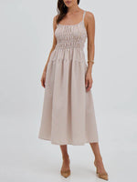 Woman wearing a beige and white striped dress on a white background