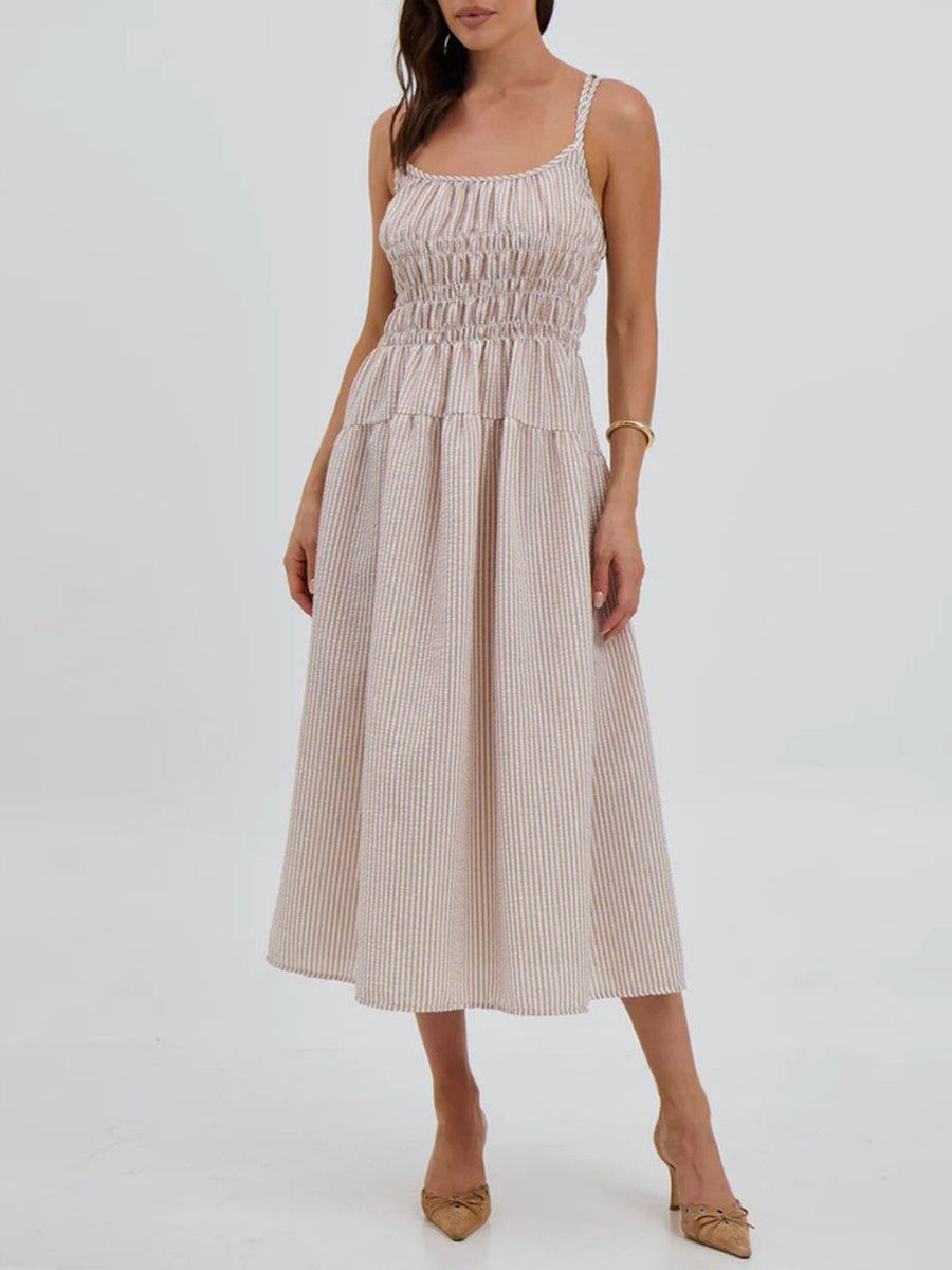 Woman wearing a beige and white striped dress on a white background