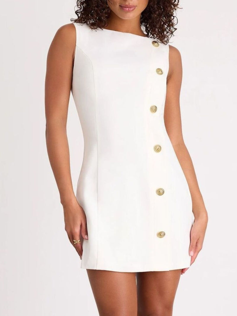 White dress with gold buttons worn by a model on a white background