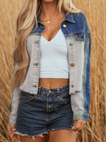 Person wearing a denim jacket and shorts with a white top against a blurred natural background