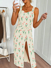 Woman wearing a floral dress in a room with a rack of clothes.
