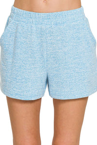 Light blue shorts worn by a person on a white background