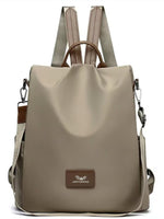 Beige backpack with brown accents on a white background