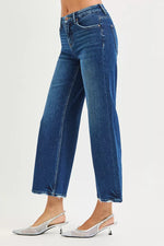 Blue jeans worn by a person on a white background