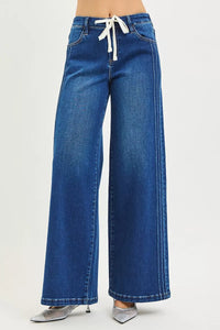 Blue wide-leg jeans with a white drawstring on a light gray background