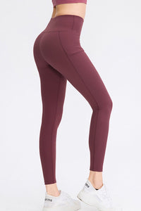 Maroon leggings worn by a person on a white background