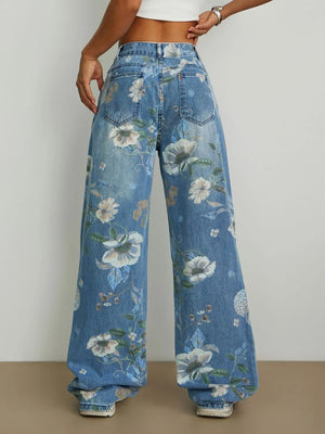 Floral-patterned jeans worn by a person on a plain background