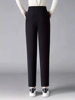 Black pants worn by a person on a gray background