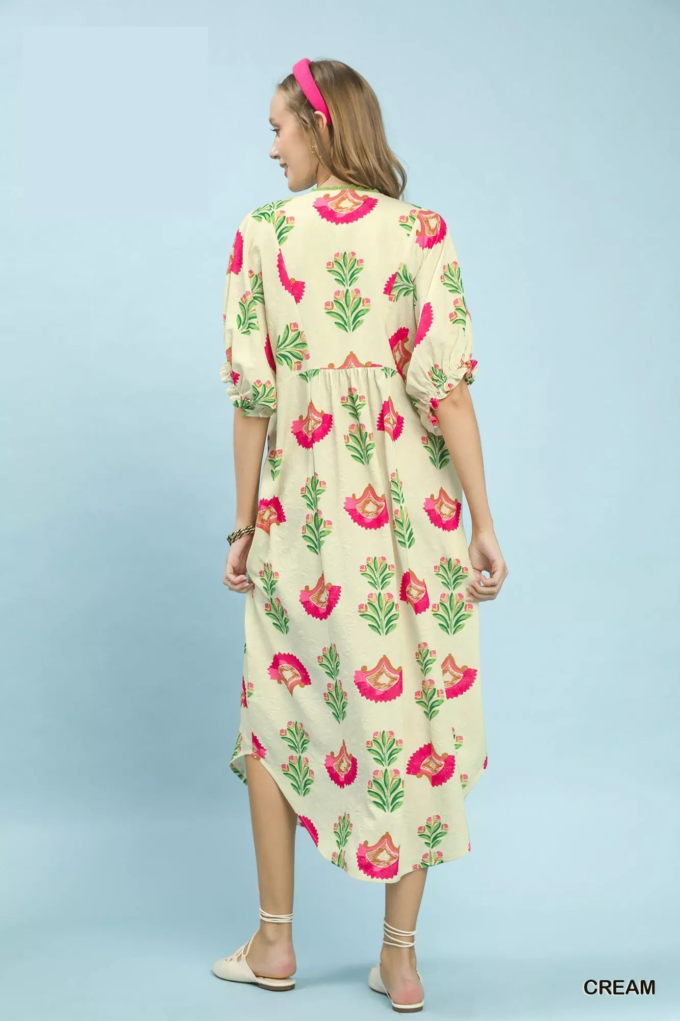 Woman wearing a floral dress on a light blue background