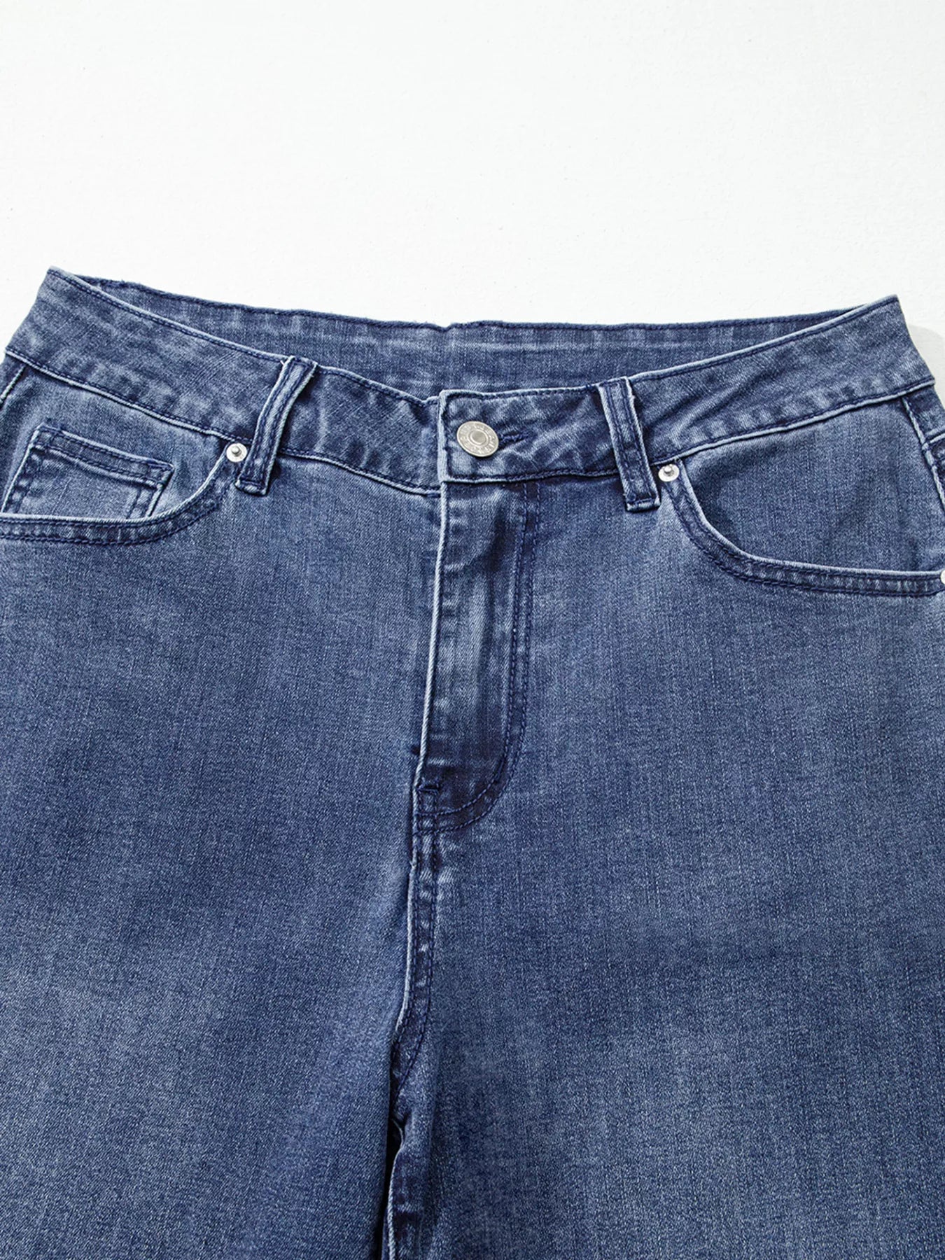 Close-up of blue jeans on a white background