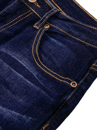 Close-up of dark blue denim fabric with orange stitching