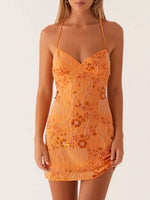 Orange lace dress with floral patterns on a white background