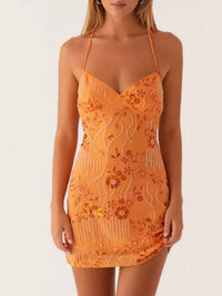 Orange lace dress with floral patterns on a white background