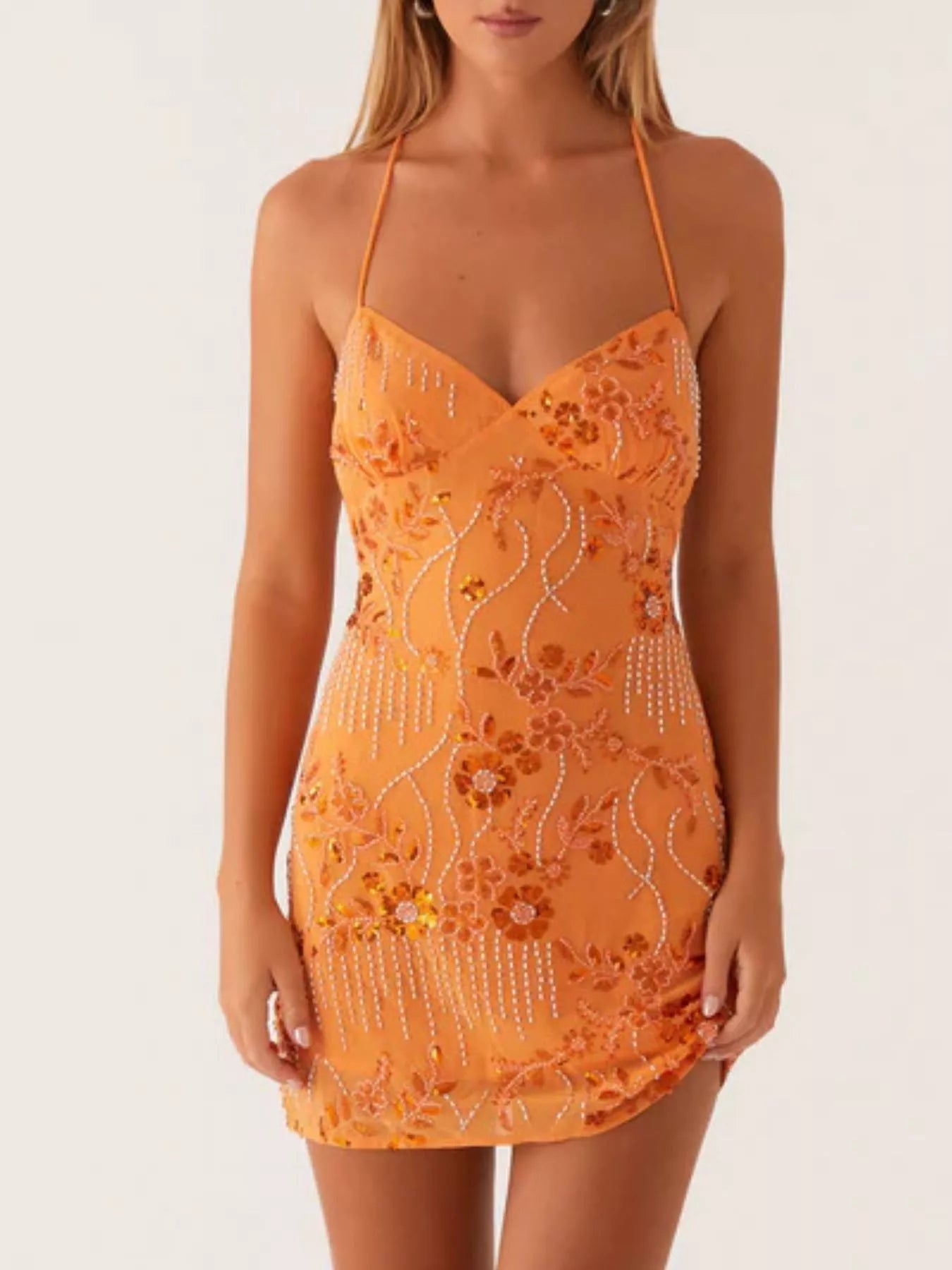 Orange lace dress with floral patterns on a white background