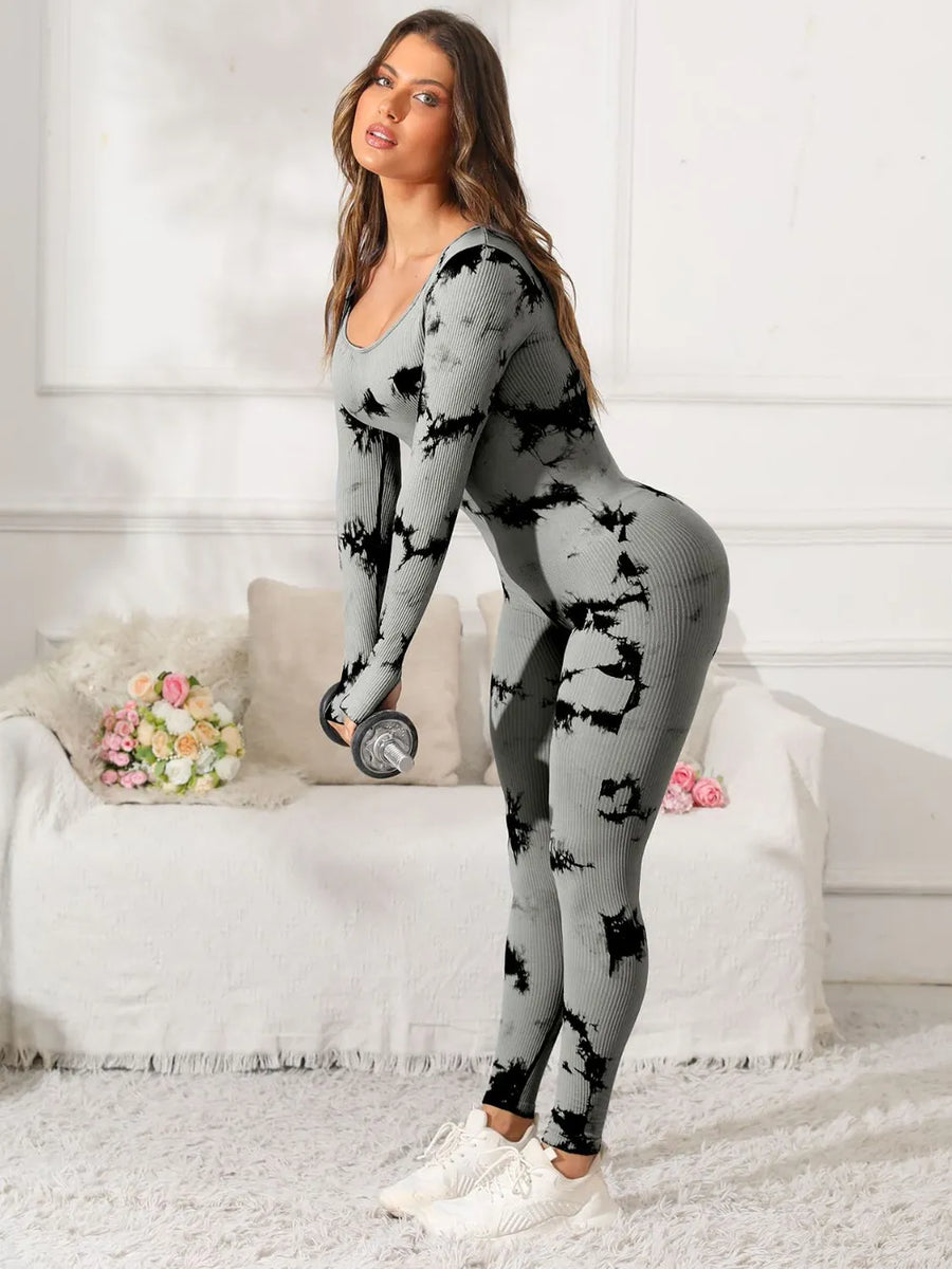 Woman wearing a gray and black tie-dye outfit in a home setting.