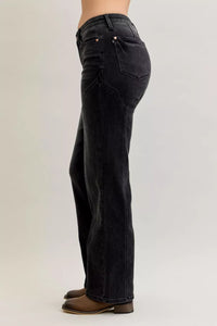 Black jeans worn by a person on a light gray background