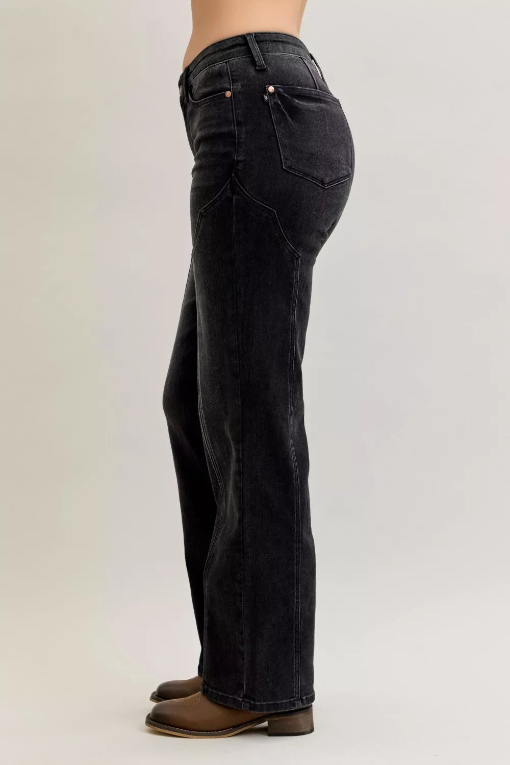 Black jeans worn by a person on a light gray background