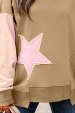 Close-up of a person wearing a sweater with a pink star design.