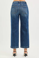Blue jeans worn by a person on a white background