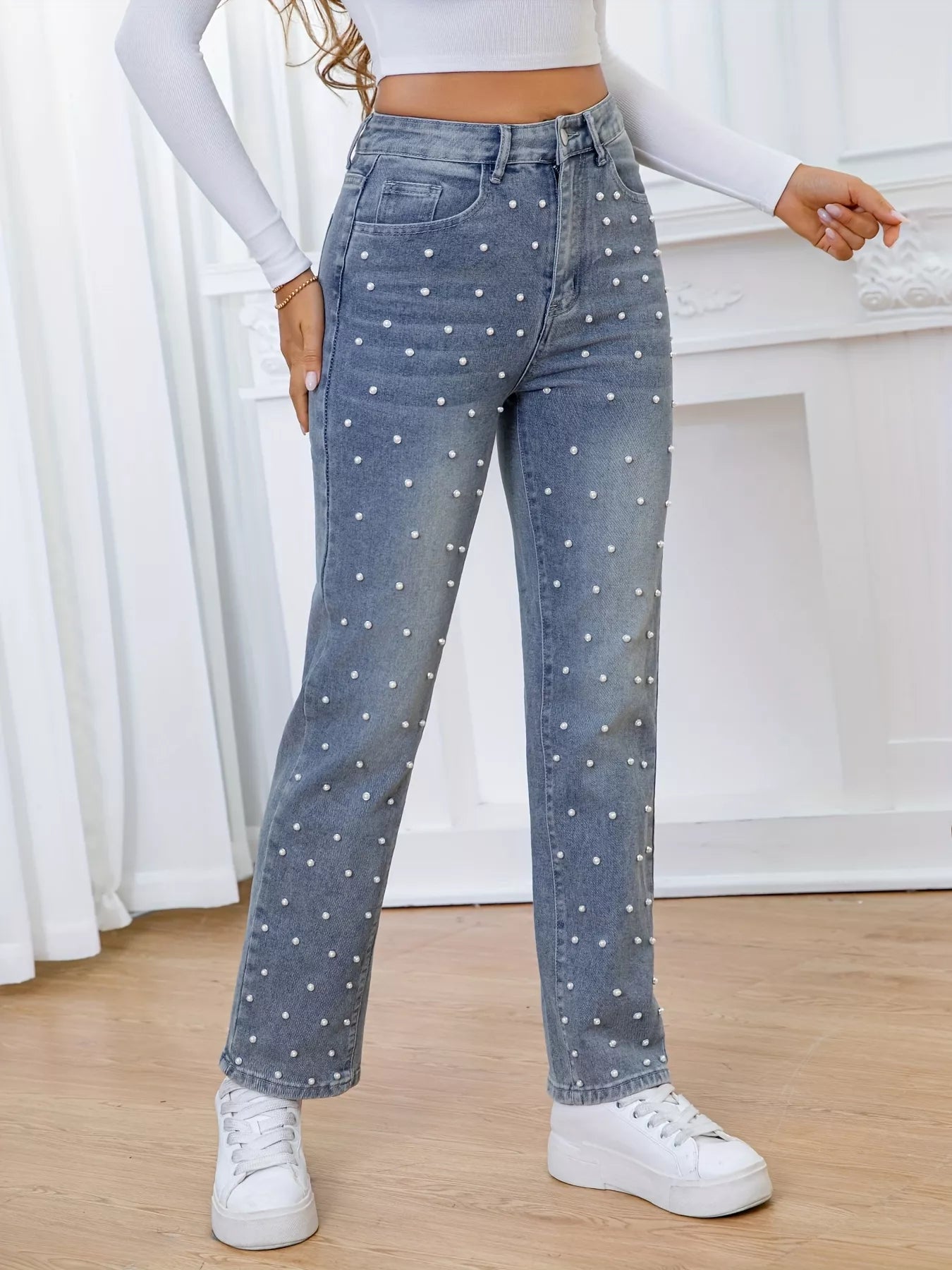 Person wearing polka dot jeans with a white background