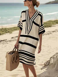 Woman on the beach wearing a beige striped dress