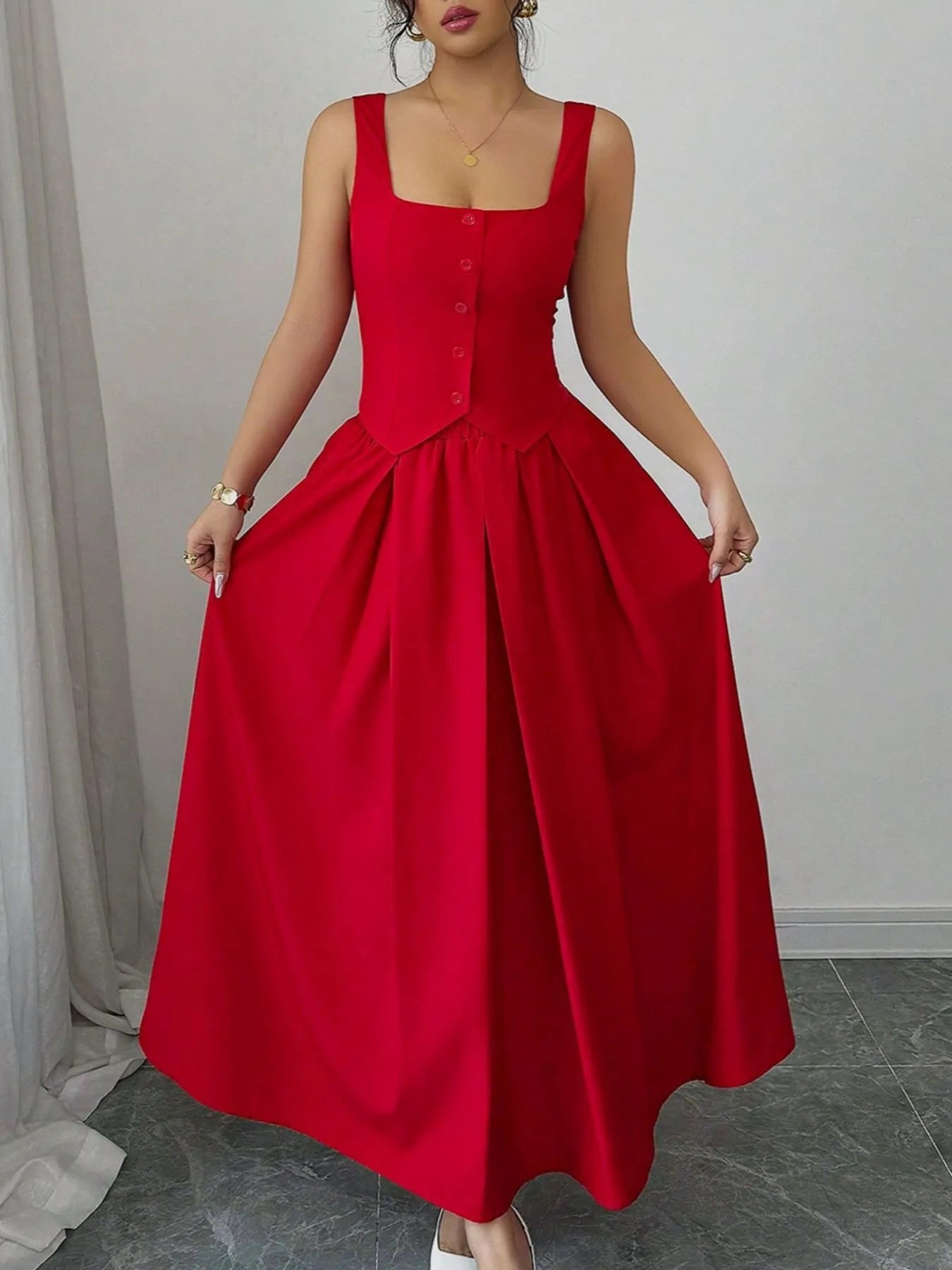 Red dress worn by a person on a plain background