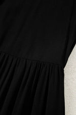 Black dress with a textured surface against a light background
