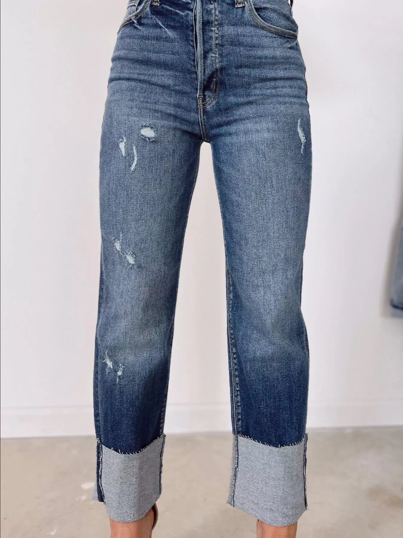 Blue distressed jeans with a white background