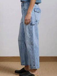 Light blue denim pants worn by a person on a neutral background
