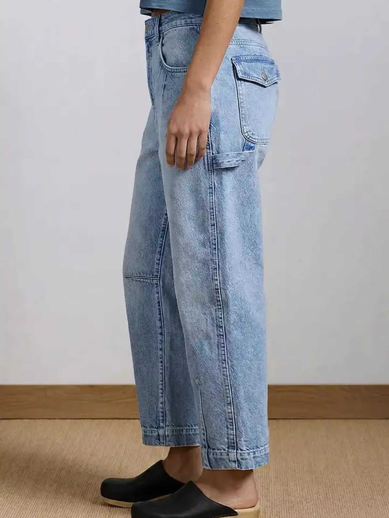 Light blue denim pants worn by a person on a neutral background