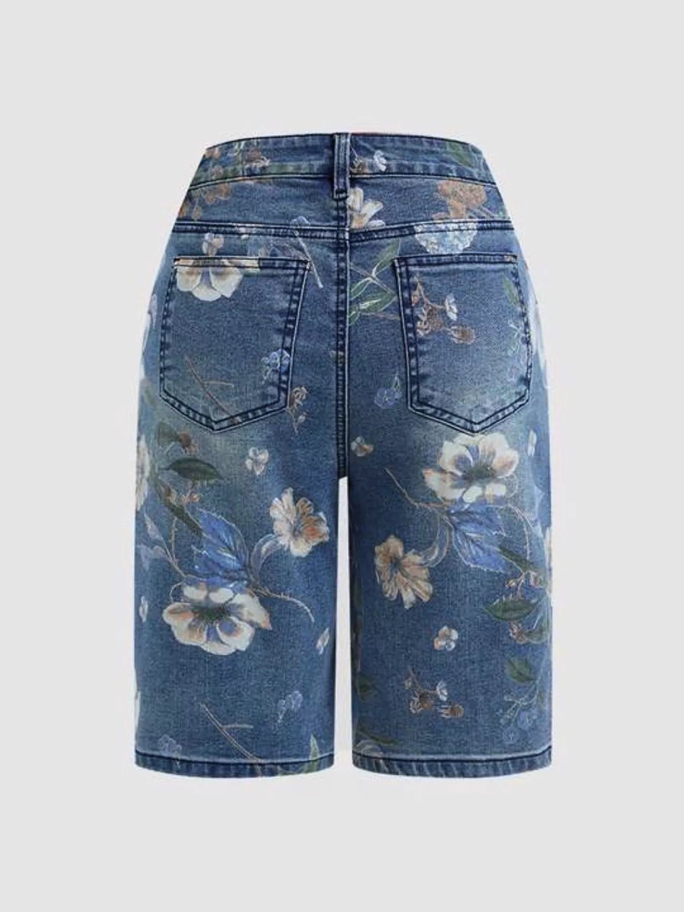 Floral-patterned denim shorts on a light gray background