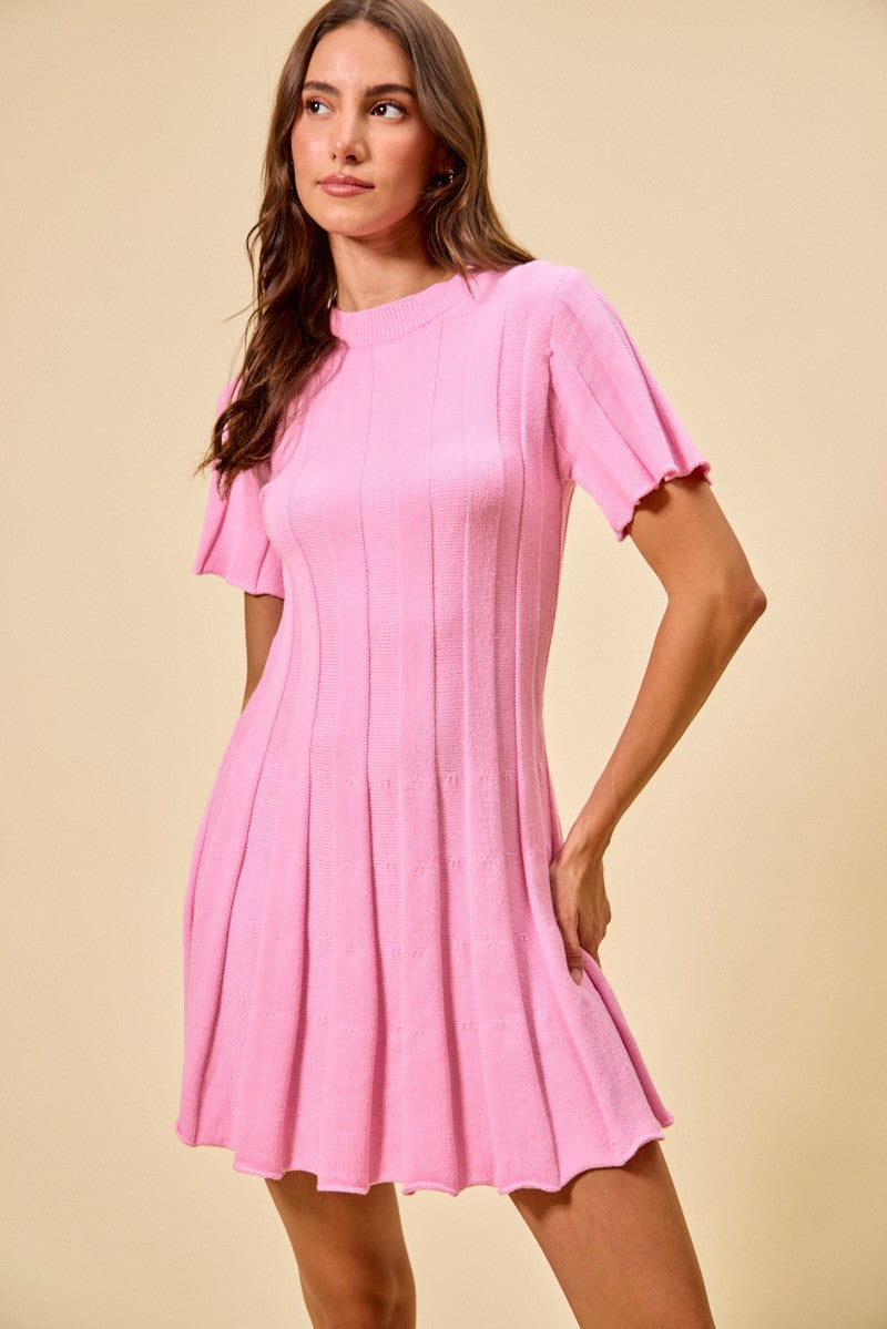 Woman wearing a pink dress against a beige background