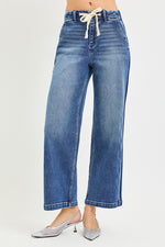 Blue jeans with a drawstring waist on a white background