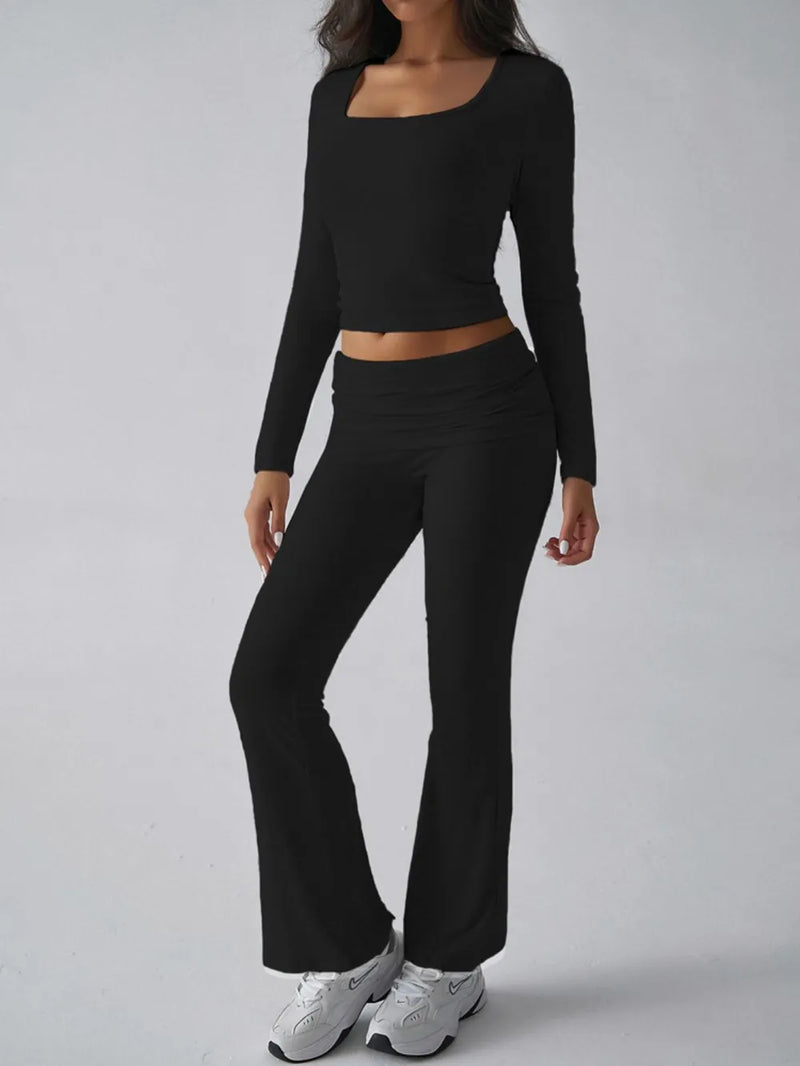 Person wearing a black long-sleeve top and black flared pants on a gray background