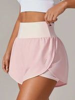 Person wearing a pink athletic skirt with a white top on a plain background