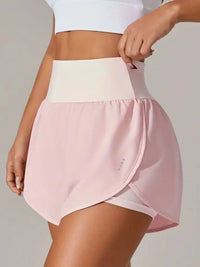 Person wearing a pink athletic skirt with a white top on a plain background