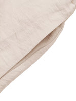Close-up of beige fabric texture on a white background